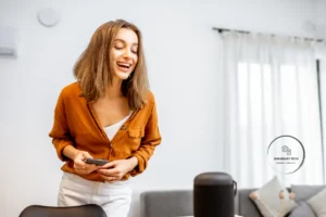 Woman using smart home voice assistant with phone | Smart Home Kits, AI Prompts & Guides for Safer, Smarter Living